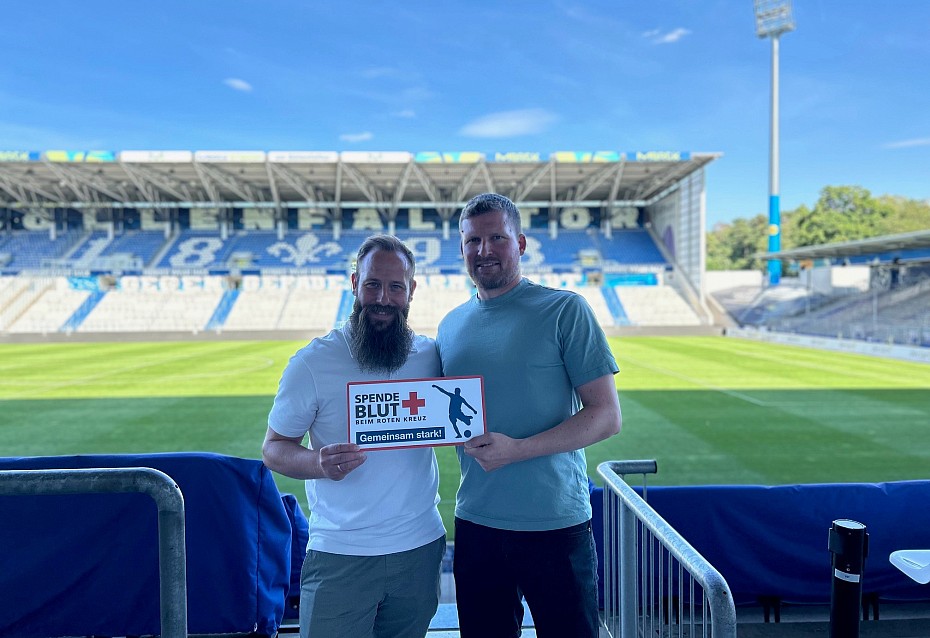 Spielder des SV Darmstadt 98 halten das Spende Blut Schild hoch